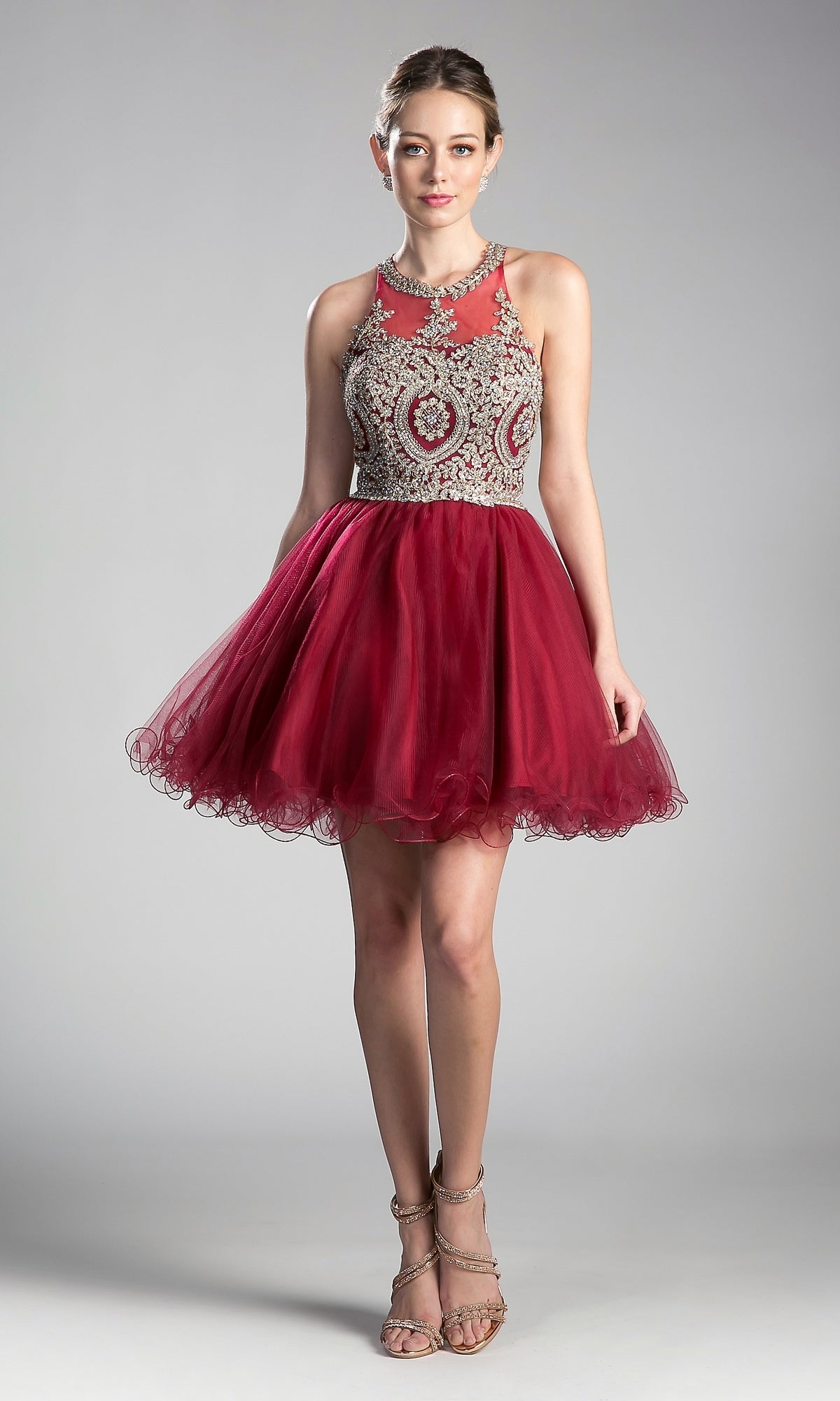 A woman models the affordable High-Neck Short Babydoll Homecoming Dress UJ0119, showcasing its beaded embroidered-lace bodice and full tulle skirt, paired with strappy heels against a simple backdrop.